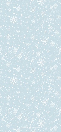 a white snowflake pattern on a light blue background