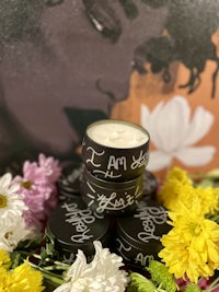 a jar of cream with flowers on top of it