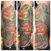 a tattoo of a jack-o-lantern and a snake