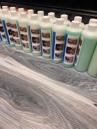a row of bottles of liquid soap on a table