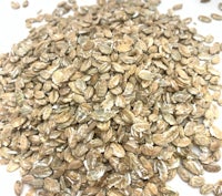 a pile of rolled oats on a white surface