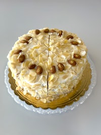 a white cake with almonds on a plate