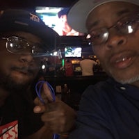 two men posing for a selfie in a bar