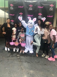 a group of people posing for a photo with an easter bunny