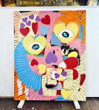 a colorful painting of a face on a stand