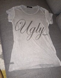 a t - shirt with the word ugly on it