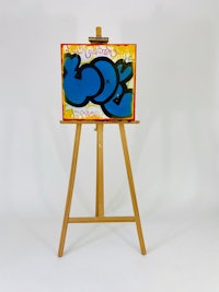 a blue easel with a blue painting on it
