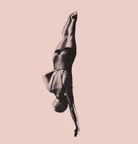 a black and white image of a woman doing a flip