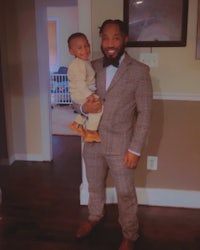 a man in a suit holding a baby