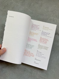 a person holding an open book with a list of recipes