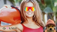 a woman in a red bikini holding a surfboard and sunglasses