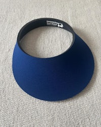 a blue visor on a white surface