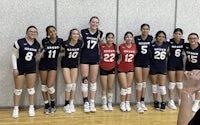 a group of female volleyball players posing for a picture
