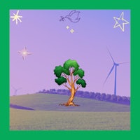 a green tree with wind turbines in the background
