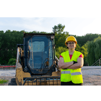 a woman standing in front of a bulldozer