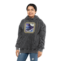 a woman wearing a gray hoodie with a picture of a cat on it