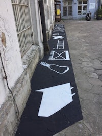 a black and white street with arrows painted on it