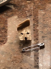 a pin with a house on it sitting on a counter