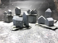 a group of small gray houses on top of rocks