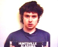 a man in a blue shirt holding up a mugshot