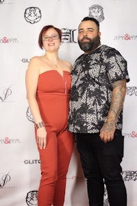a man and woman posing for a photo on the red carpet