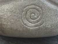 a ceramic pot with a spiral design on it