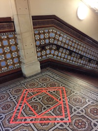 a red line on a tiled floor