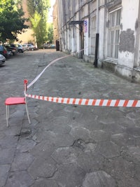 a chair with a red and white tape in front of a building