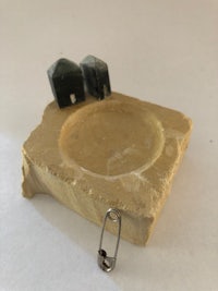 a small piece of stone with a piece of metal on it