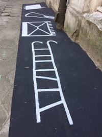 a chalk drawing of a ladder on a sidewalk