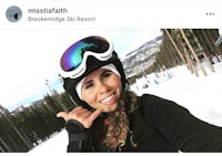 a woman wearing ski goggles on a ski slope