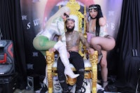 two women sitting on a gold throne