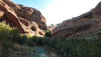 a dirt trail in the middle of a red rock canyon