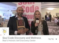 a man and woman holding a book with the title soul code and wellness