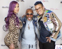 three people posing for a photo at an event