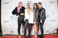 a group of people posing on a red carpet