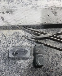 a pair of tweezers and a piece of stone on a table