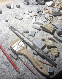 a pile of rocks and tools on a table