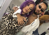 a man and woman with purple hair posing for a photo