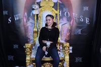 a woman sitting on a gold throne