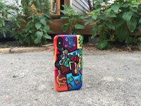 a colorful phone case sitting on the ground
