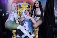 three women sitting on a gold throne