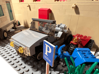 a lego model of a car and a truck in a parking lot