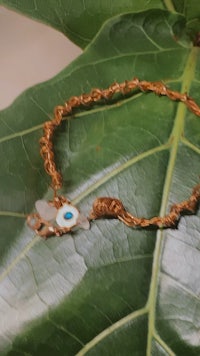 an evil eye bracelet on a leaf