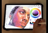 a person drawing a portrait on an ipad