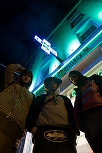 a group of people standing in front of a building at night