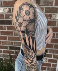 a woman with black and white flowers on her sleeve