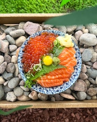 japanese caviar on a plate surrounded by rocks