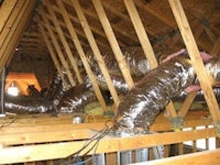 an attic with ducts and pipes in it