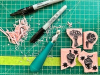 rubber stamps and markers on a cutting board